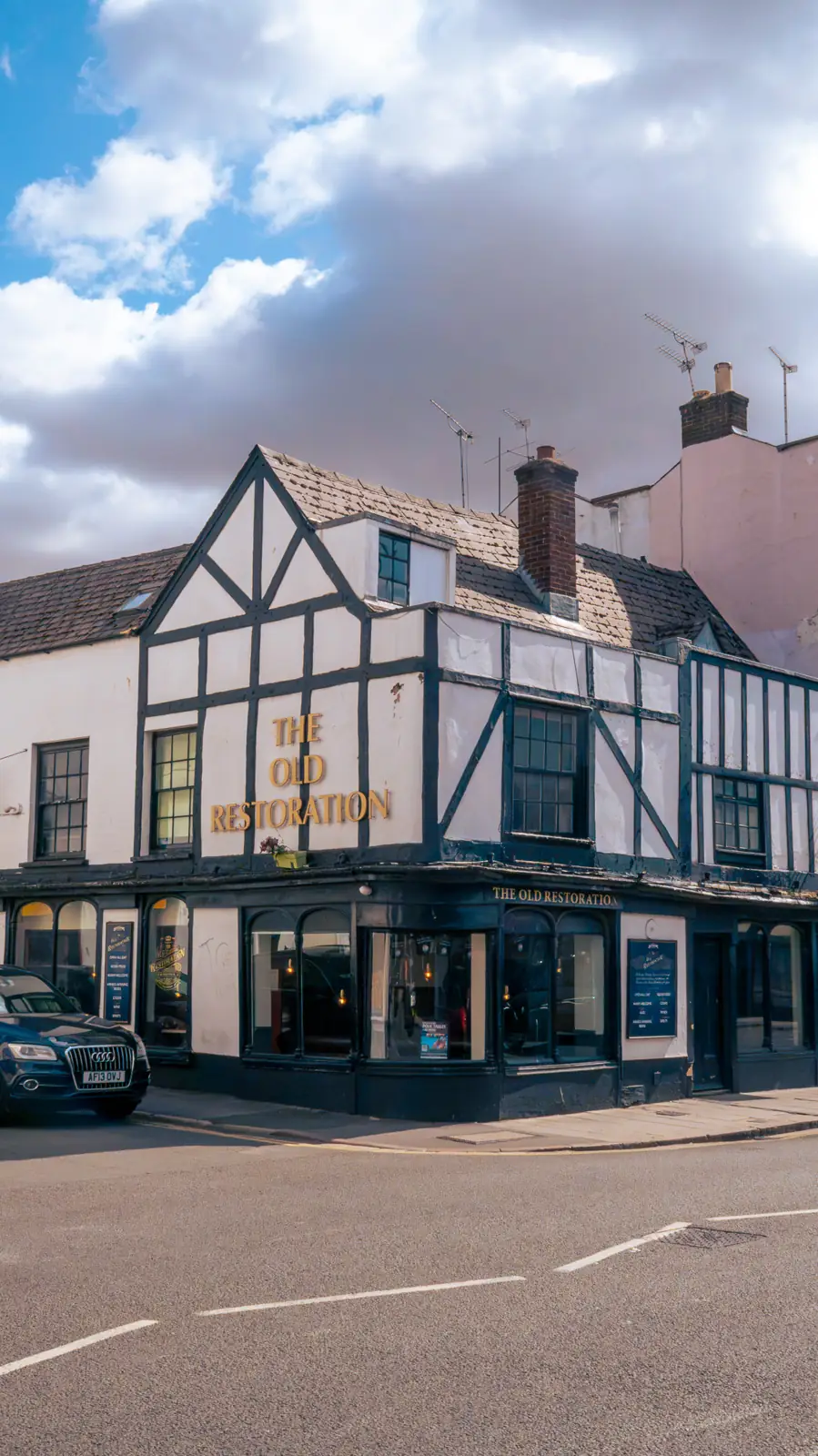 The Old Restoration's black and white timber-framed front on the corner of the High Street